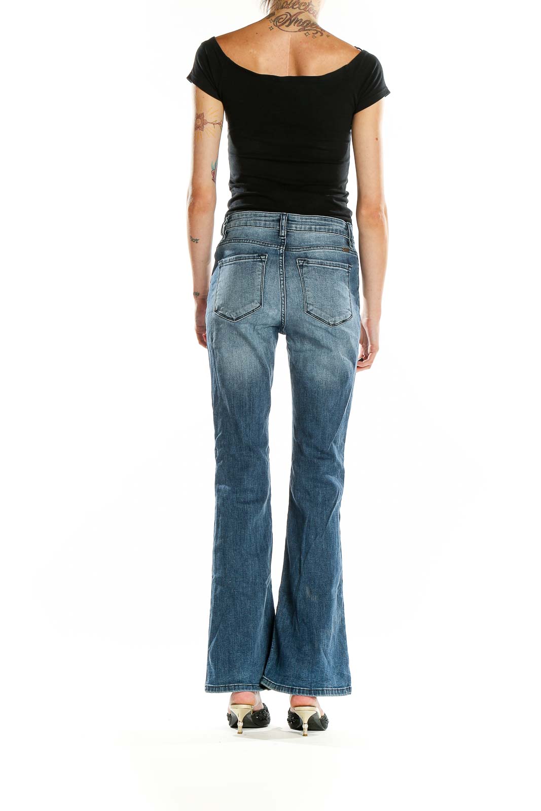 Back view of Kancan blue distressed flare jeans on model