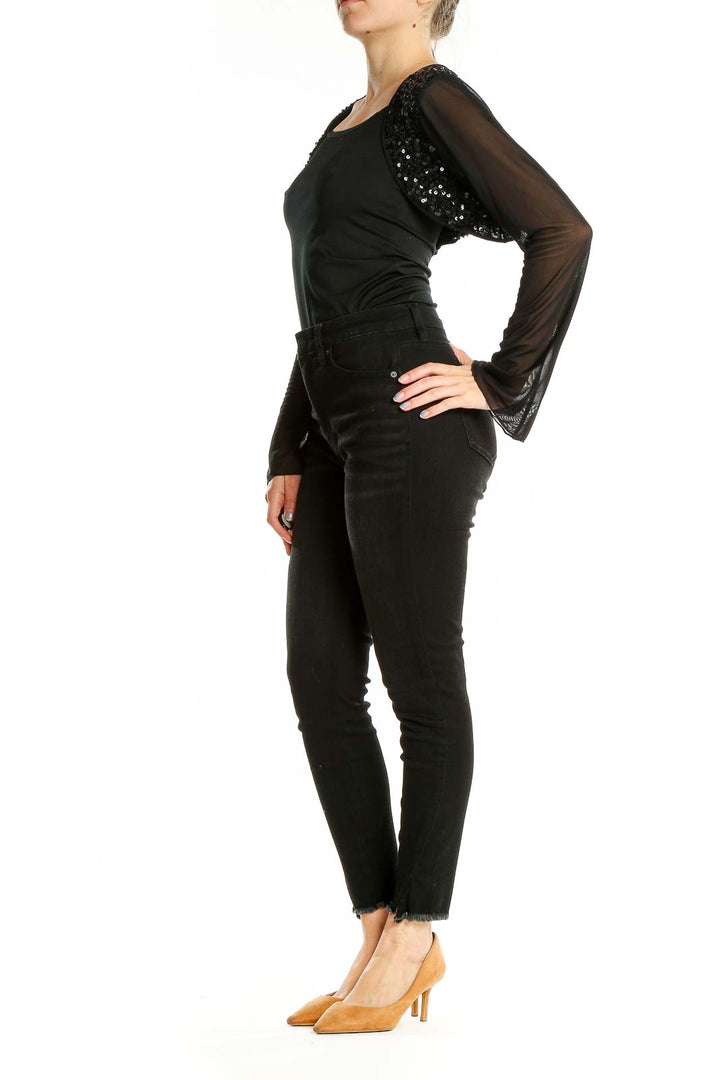 Front view of black sequined crop top with sheer sleeves