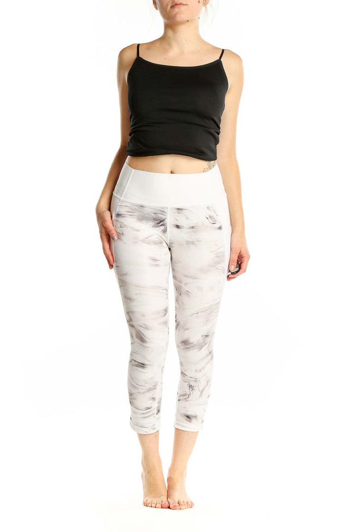 Front view of GapFit white marble print capri leggings on model