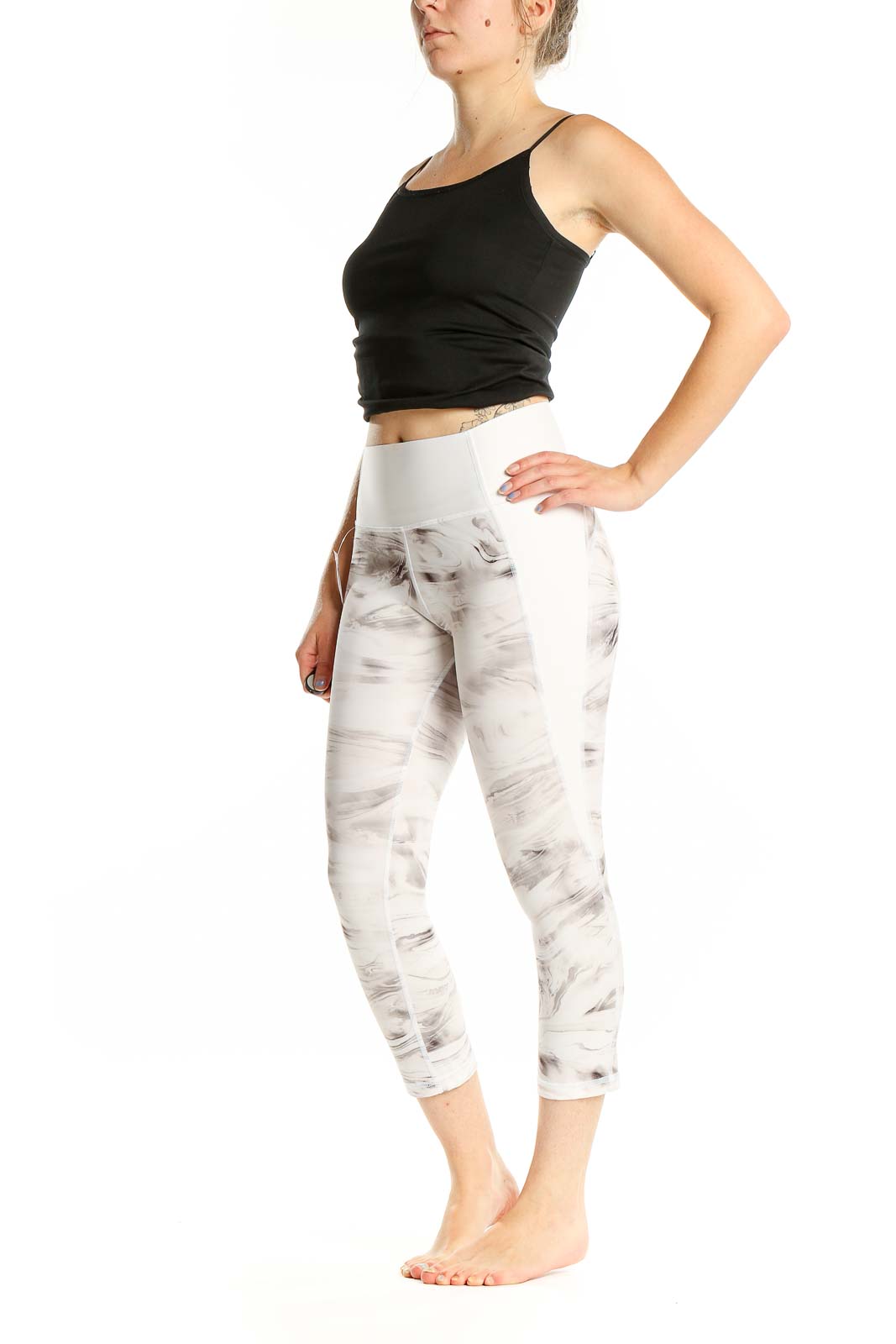 Front view of GapFit white marble print capri leggings on model