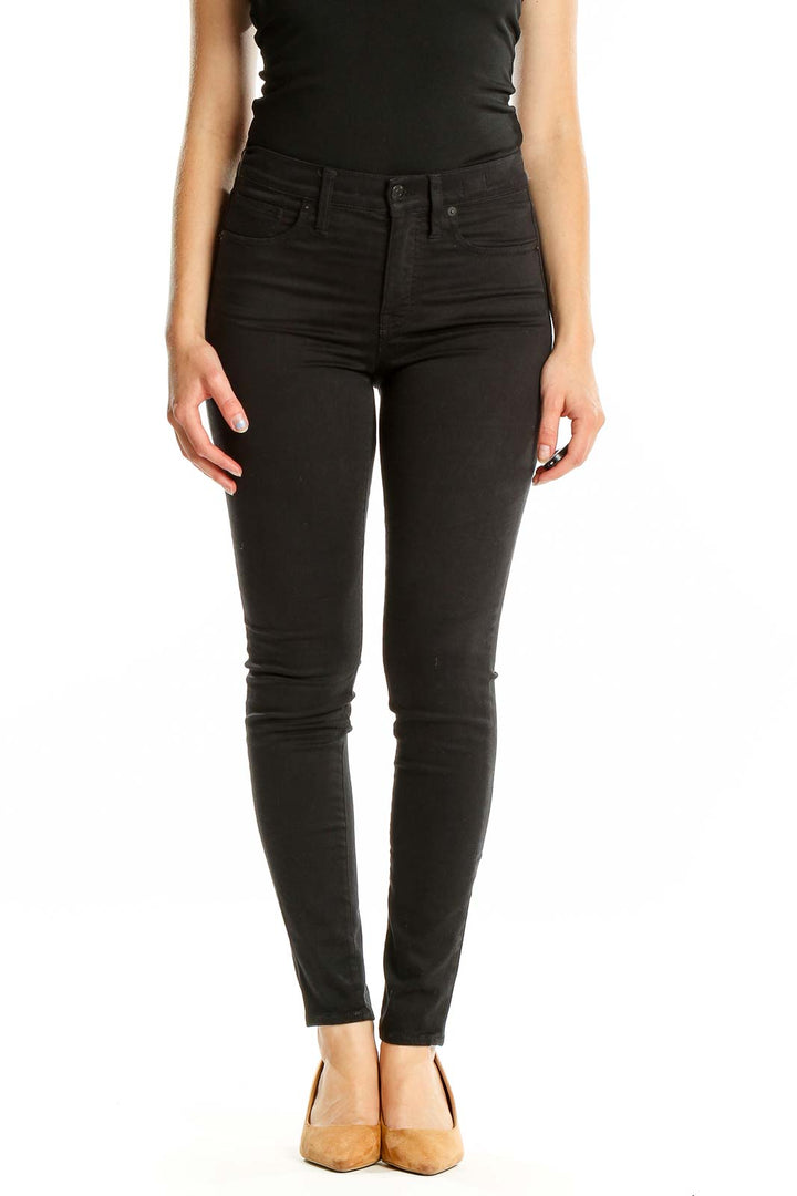 Front view of Madewell black high-waisted skinny jeans on model