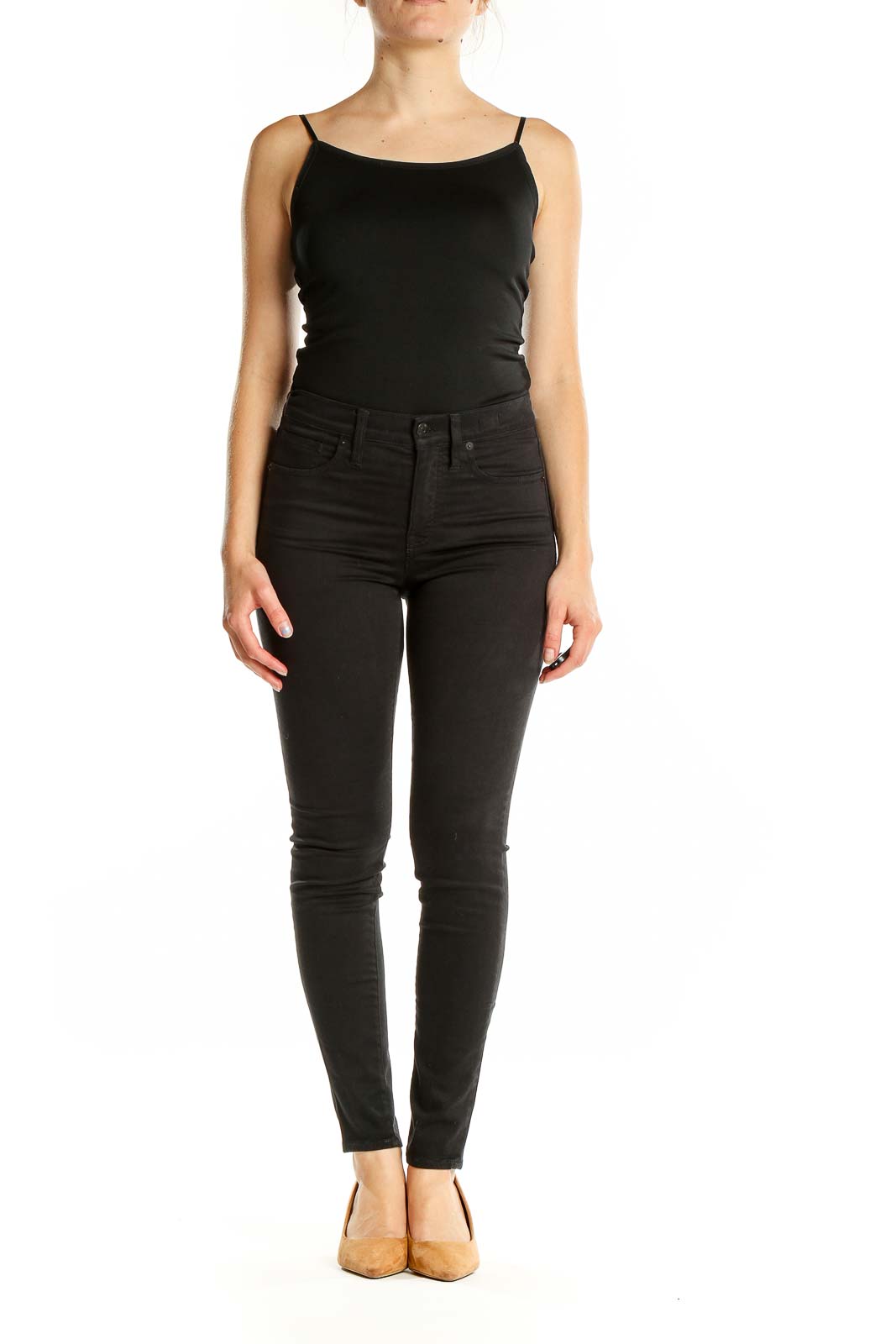 Front view of Madewell black high-waisted skinny jeans on model