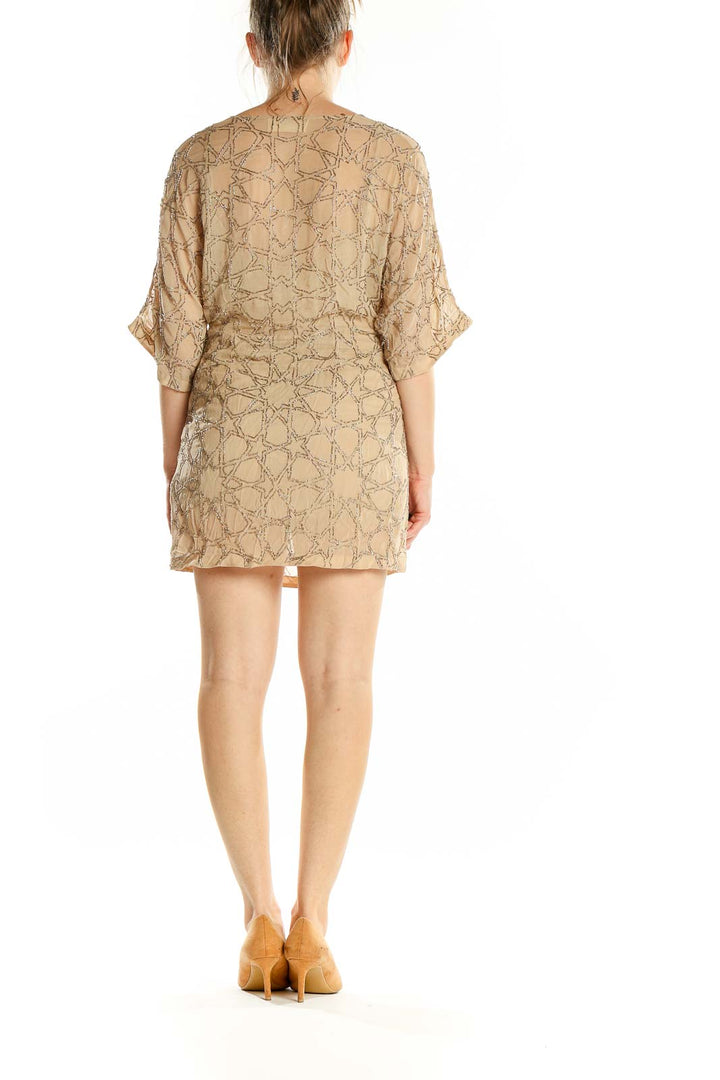 Back view of Needle & Thread beige mini dress showing embroidery pattern