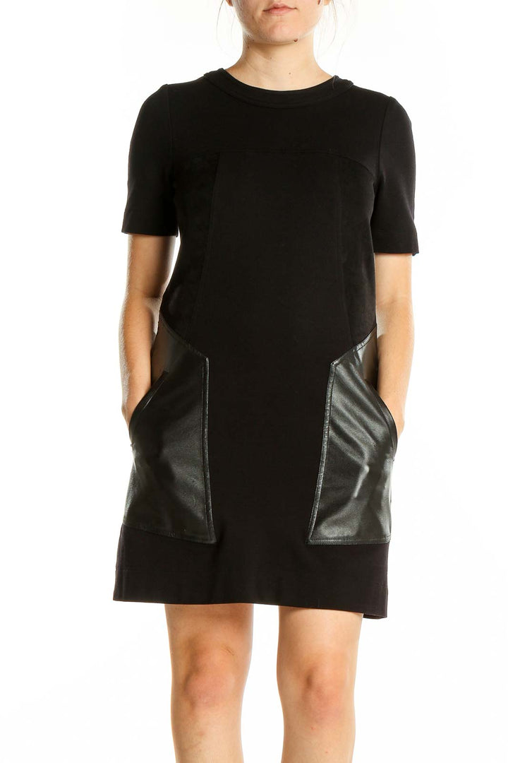 Front view of BCBG MaxAzria black mini dress with faux leather pockets