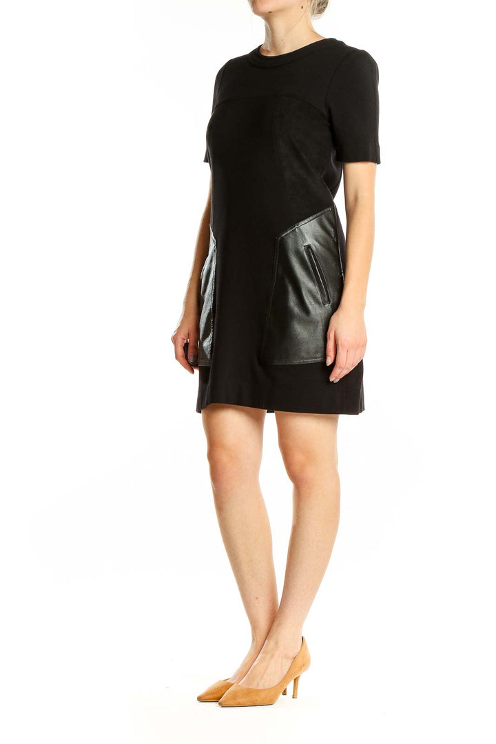 Front view of BCBG MaxAzria black mini dress with faux leather pockets