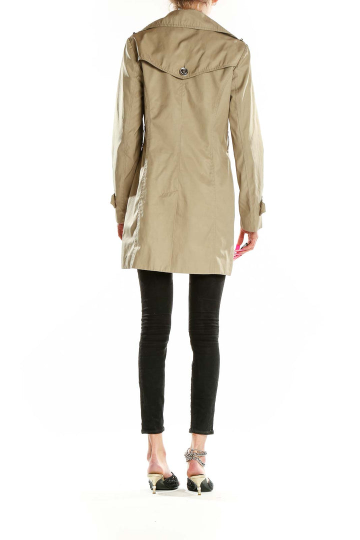 Back view of MICHAEL Michael Kors beige double-breasted trench coat with belt