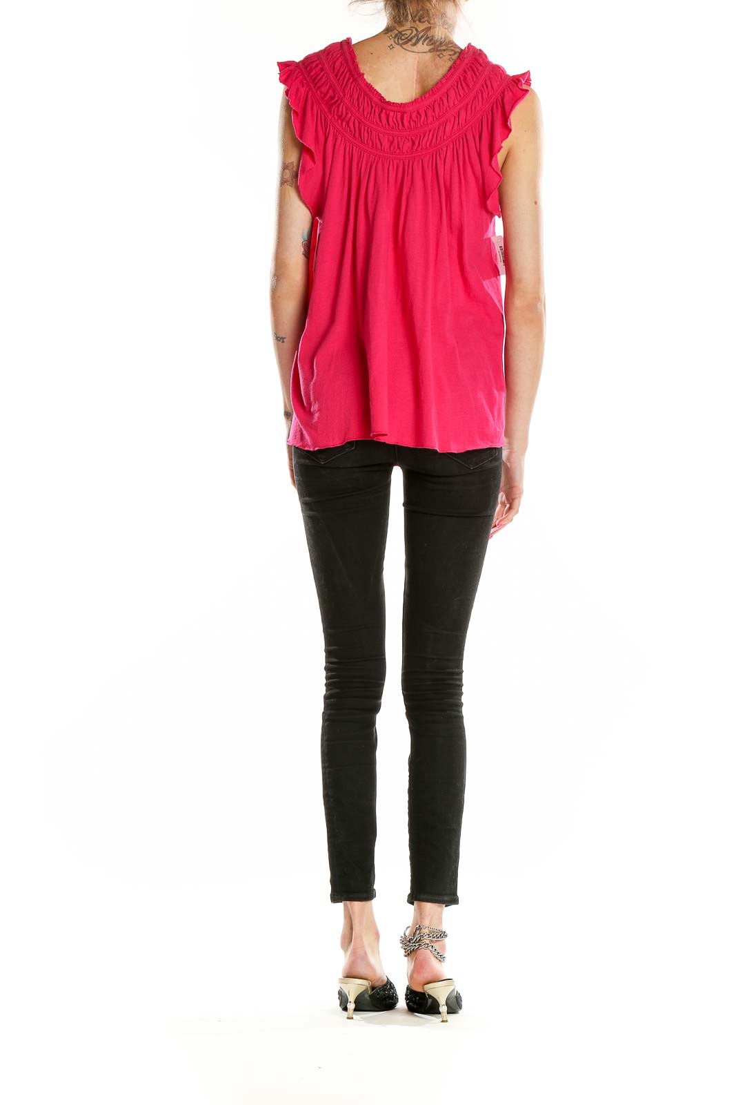 Back view of hot pink flowy rayon top by WE THE FREE paired with black jeans