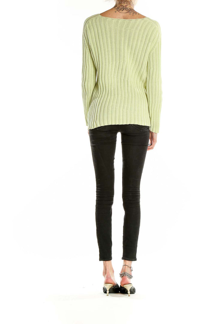 Back view of Burberry light green ribbed cotton sweater on model with black pants