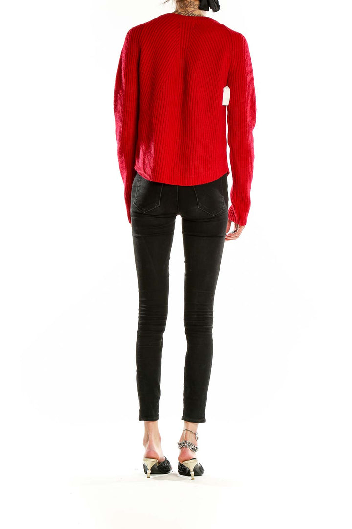 Side view of Cynthia Rowley red ribbed acrylic-wool sweater on model