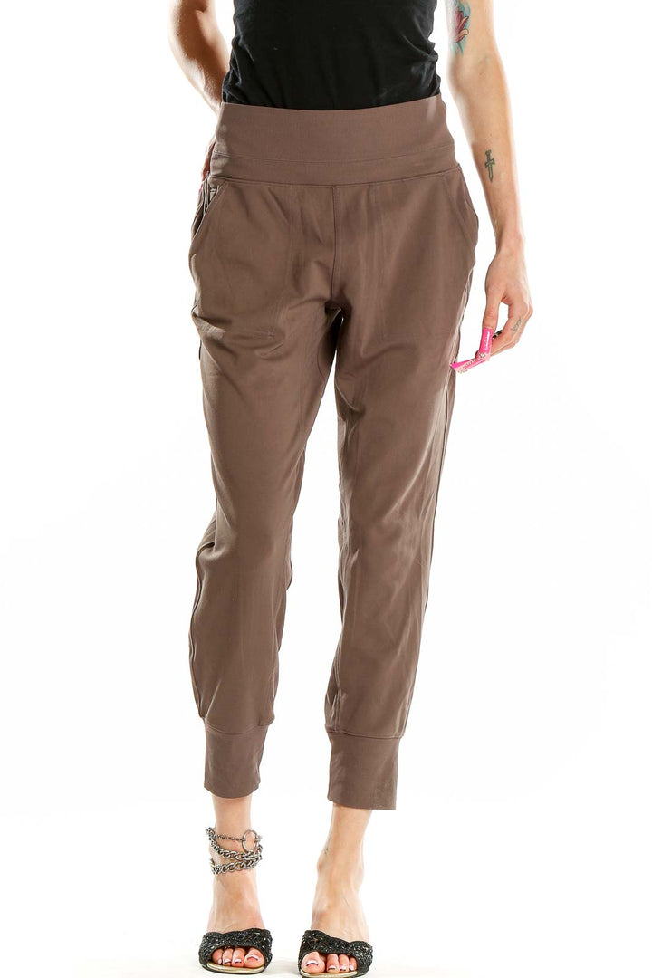 Front view of Athleta brown nylon-spandex jogger pants with high waistband and tapered legs