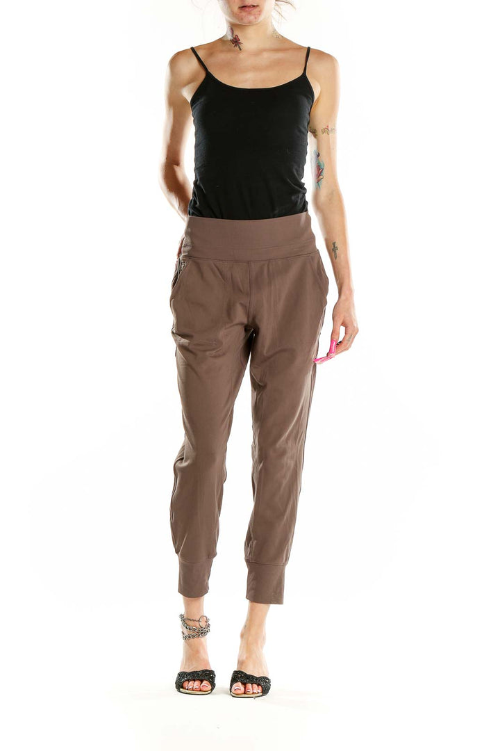 Front view of Athleta brown nylon-spandex jogger pants with high waistband and tapered legs