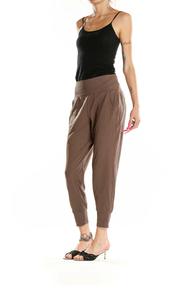 Front view of Athleta brown nylon-spandex jogger pants with high waistband and tapered legs