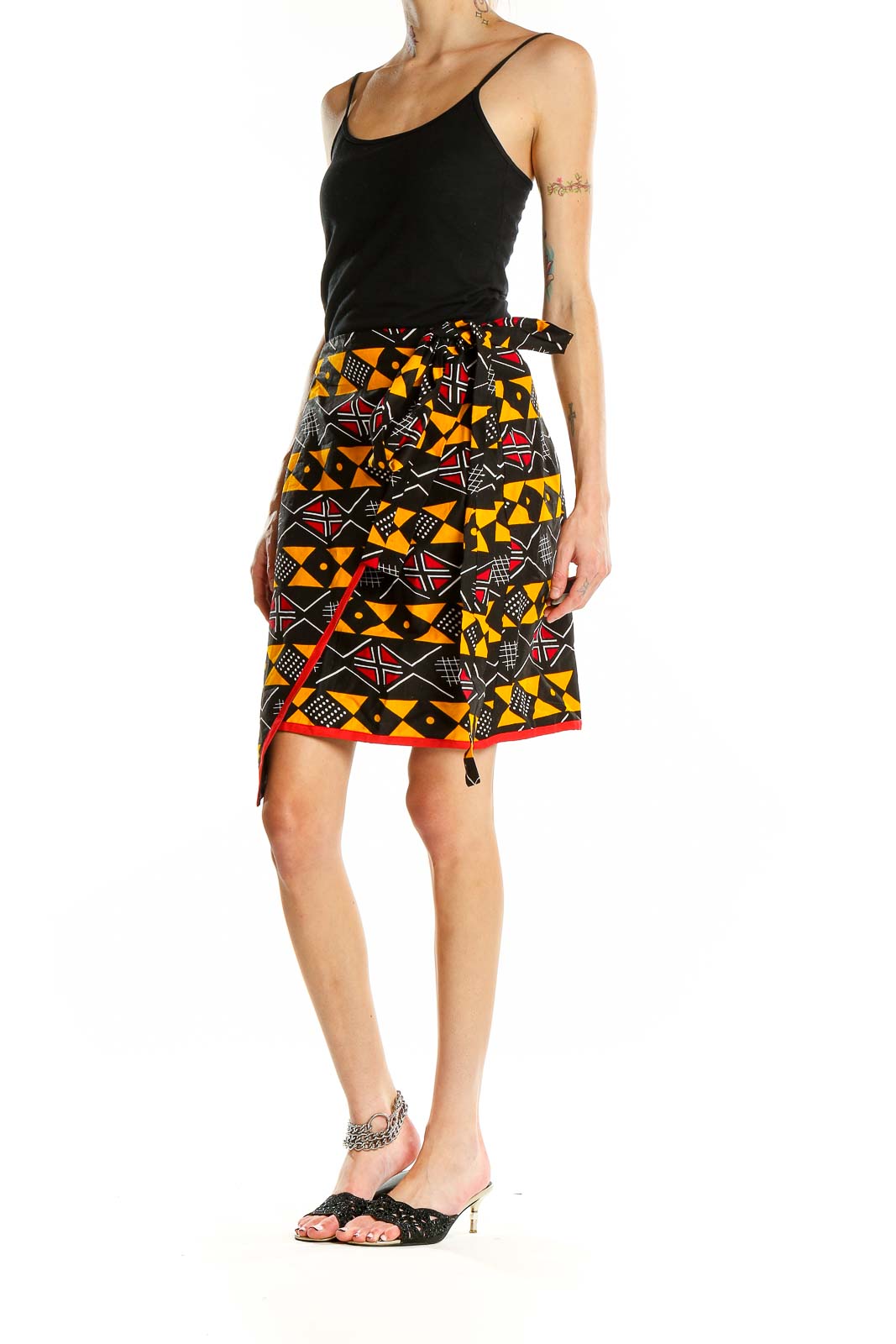 Front view of Heritage Clothing geometric print wrap skirt with black, orange, and red pattern