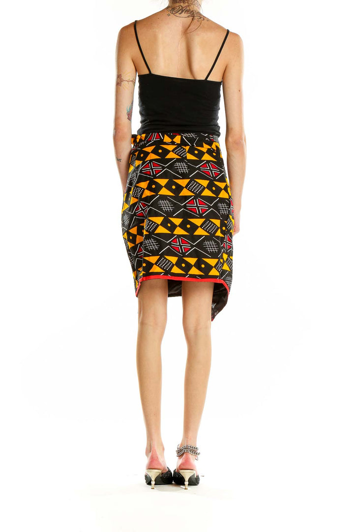 Side view of Heritage Clothing geometric print wrap skirt showing asymmetrical hemline and side tie