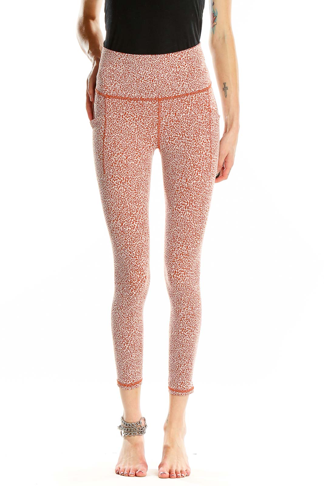 Front view of pink leopard print Athleta leggings on model