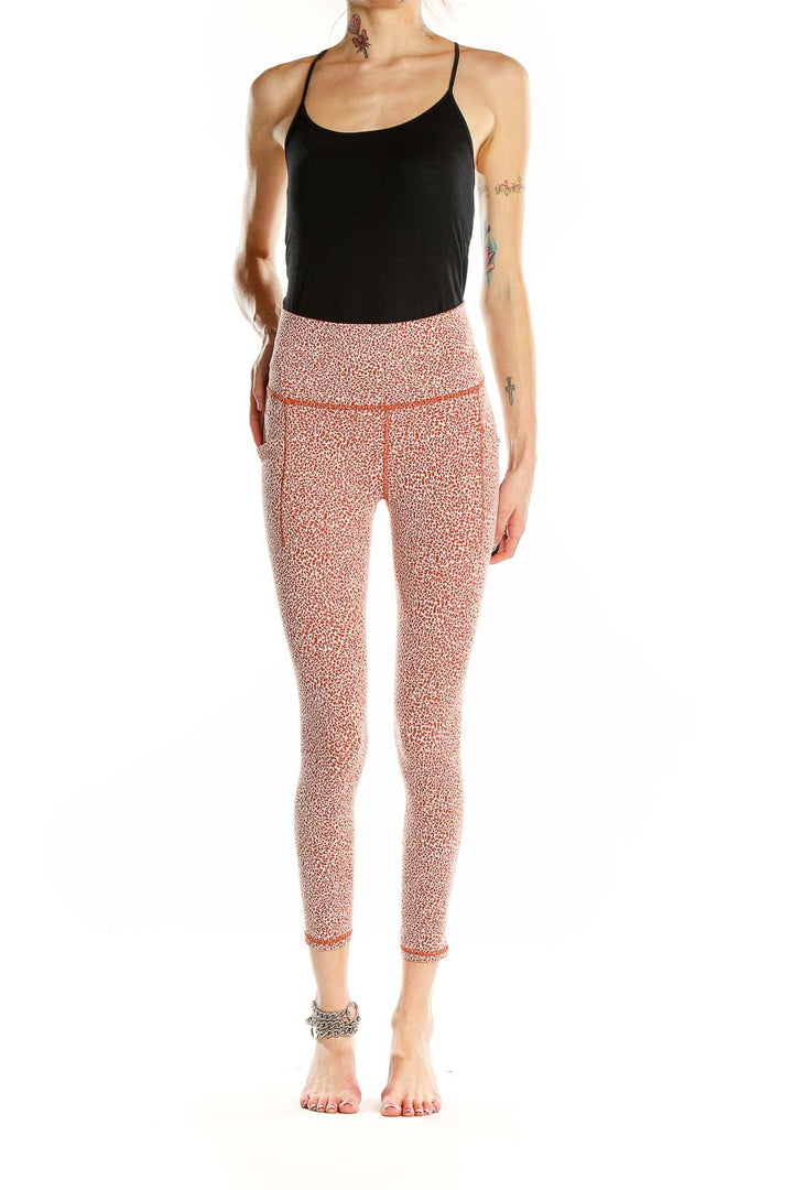 Front view of pink leopard print Athleta leggings on model