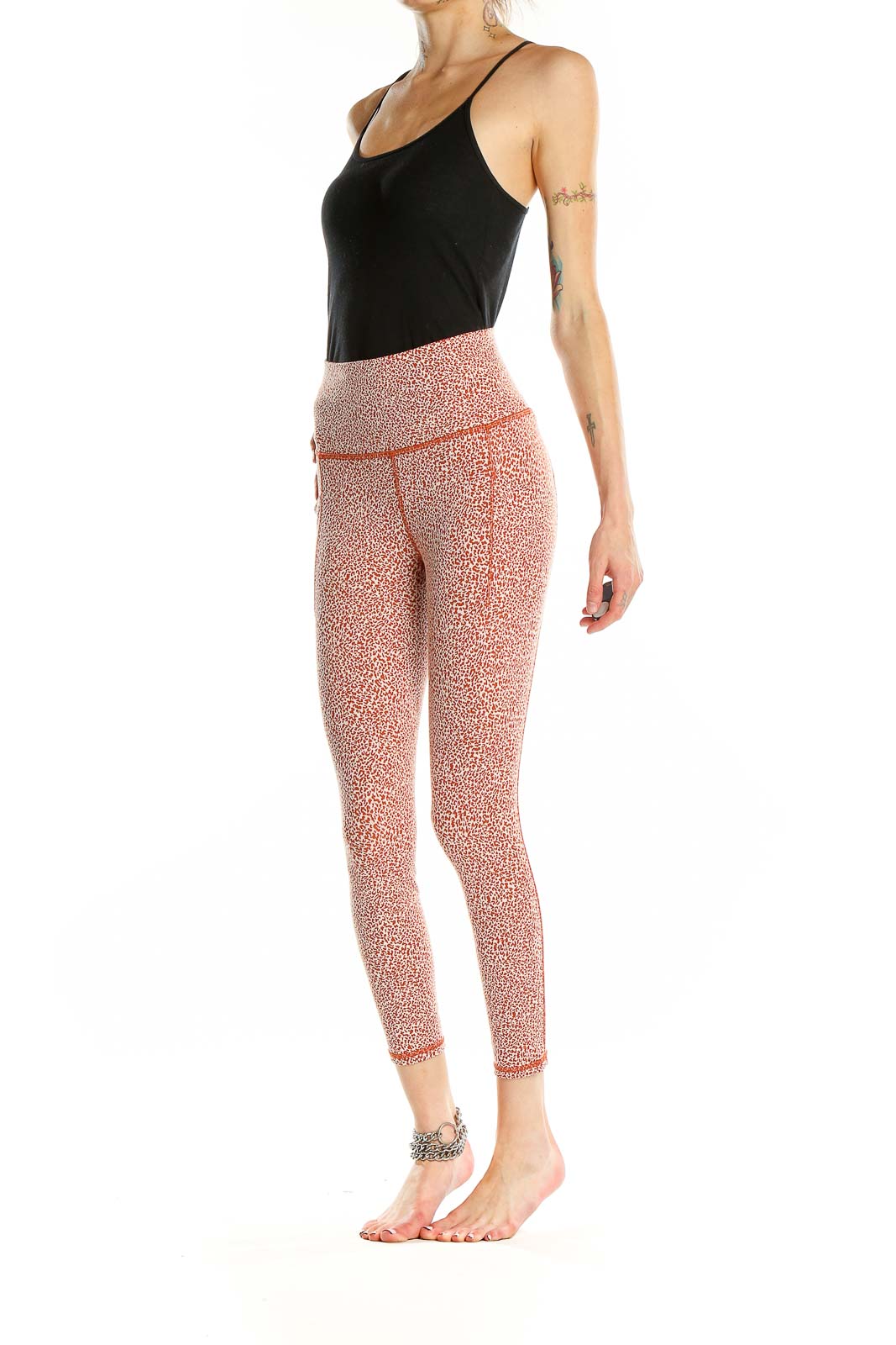 Front view of pink leopard print Athleta leggings on model