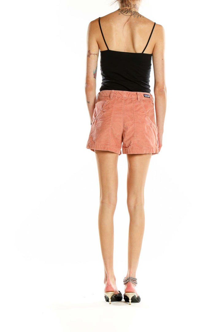 Side view of coral Patagonia organic cotton blend shorts on model