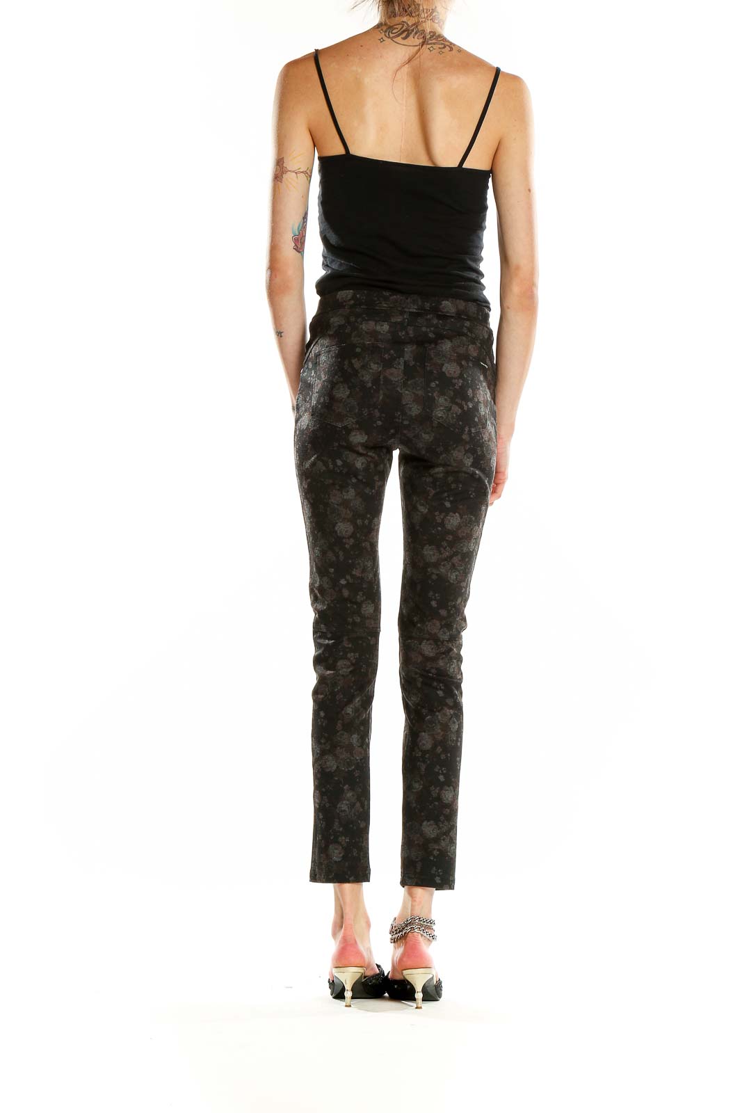 Side view of Sanctuary black floral print slim fit pants on model