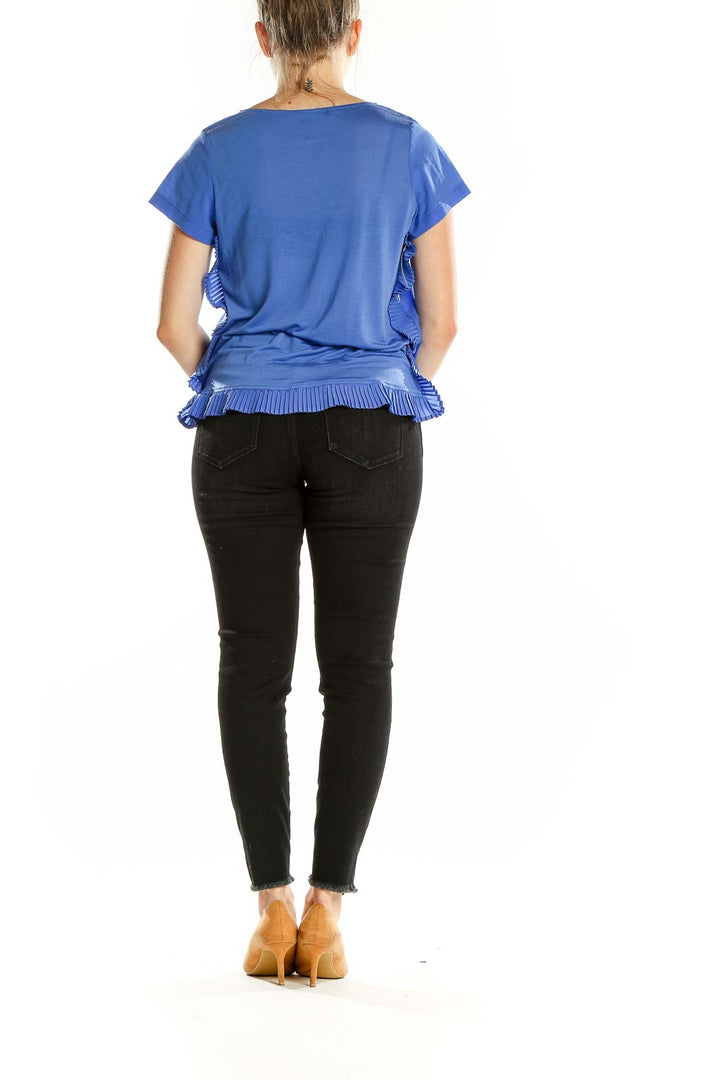 Back view of French Connection blue ruffled short-sleeve blouse showing ruffle detail