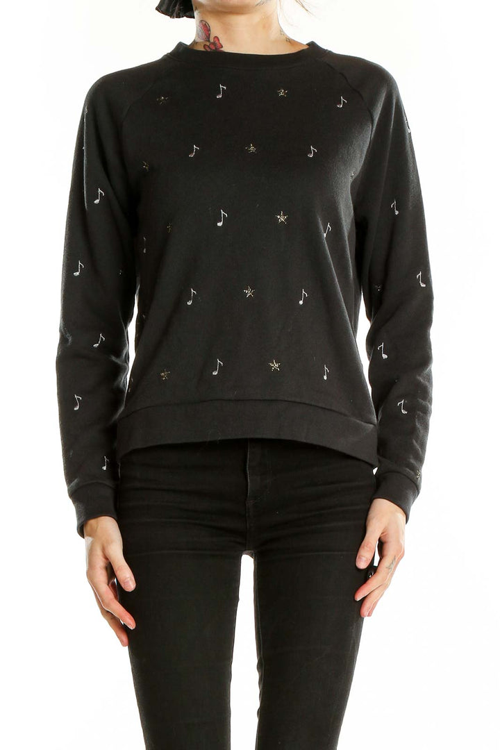 Front view of Levi's black sweatshirt with musical note and star embellishments