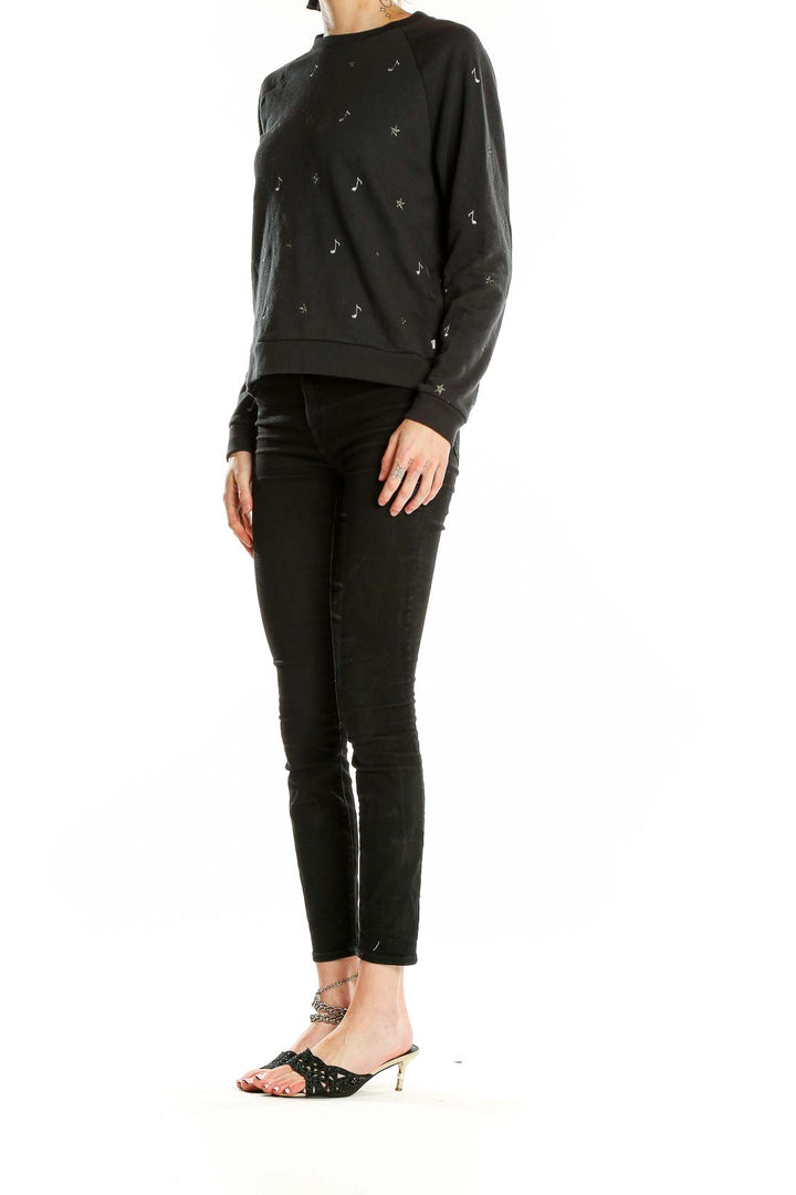 Front view of Levi's black sweatshirt with musical note and star embellishments