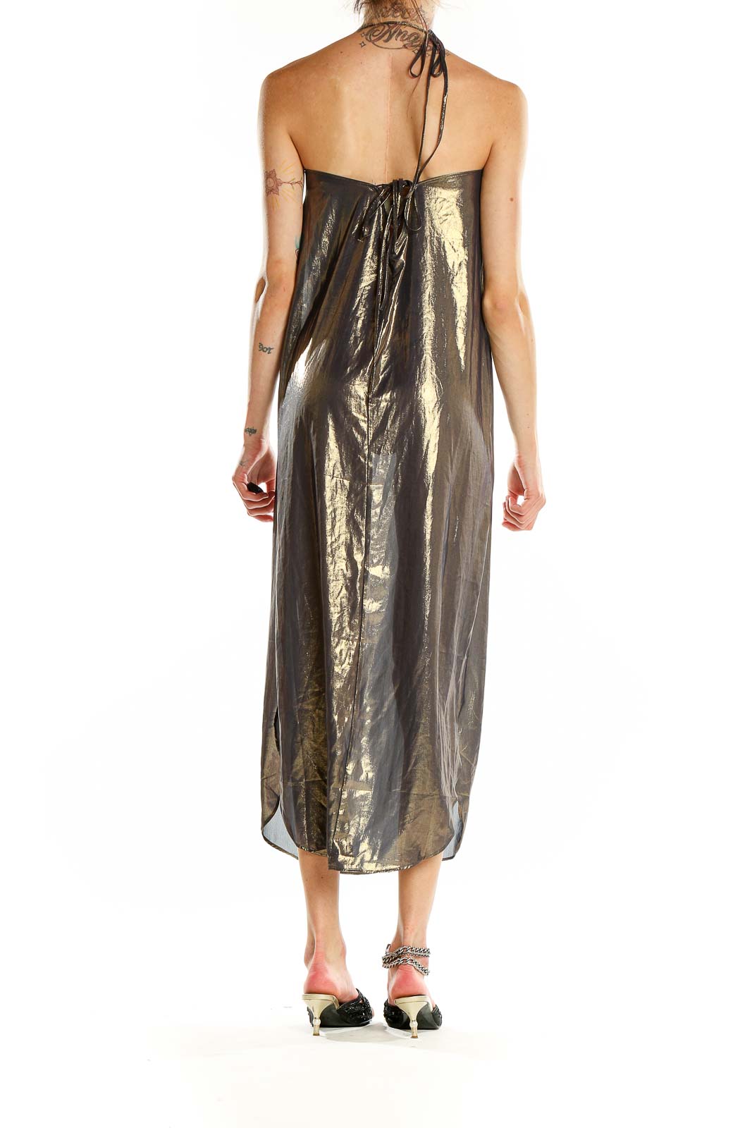 Side view of gold metallic halter maxi dress showing flowing silhouette