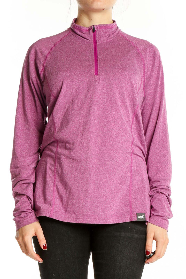 Front view of pink REI quarter-zip activewear top on model