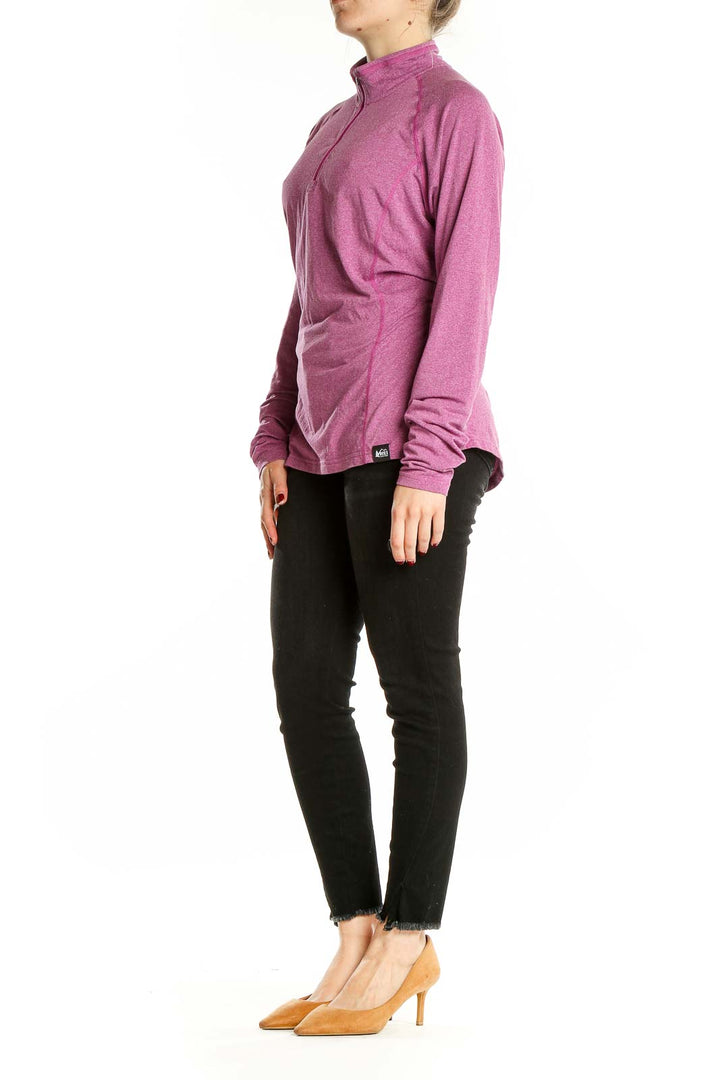 Front view of pink REI quarter-zip activewear top on model