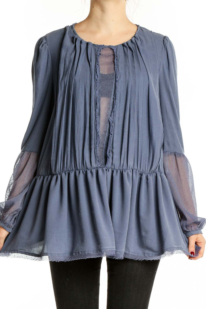 Front view of blue Free People peplum top with sheer sleeves and keyhole detail