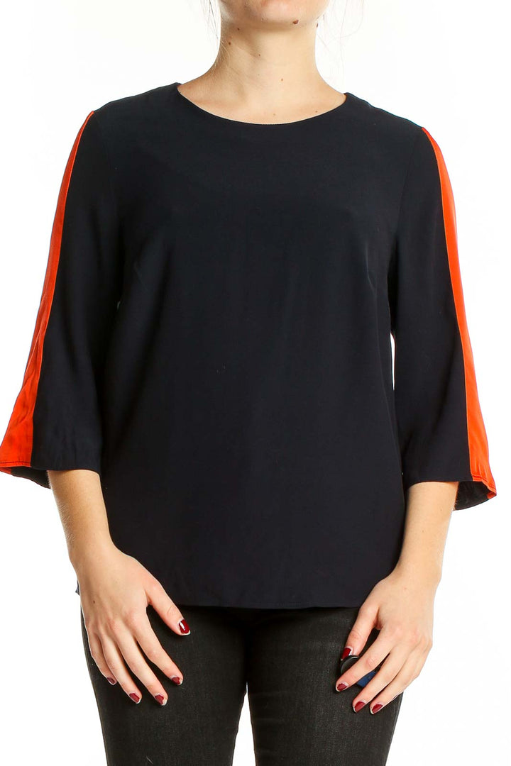 Front view of Boden black blouse with orange sleeve accents