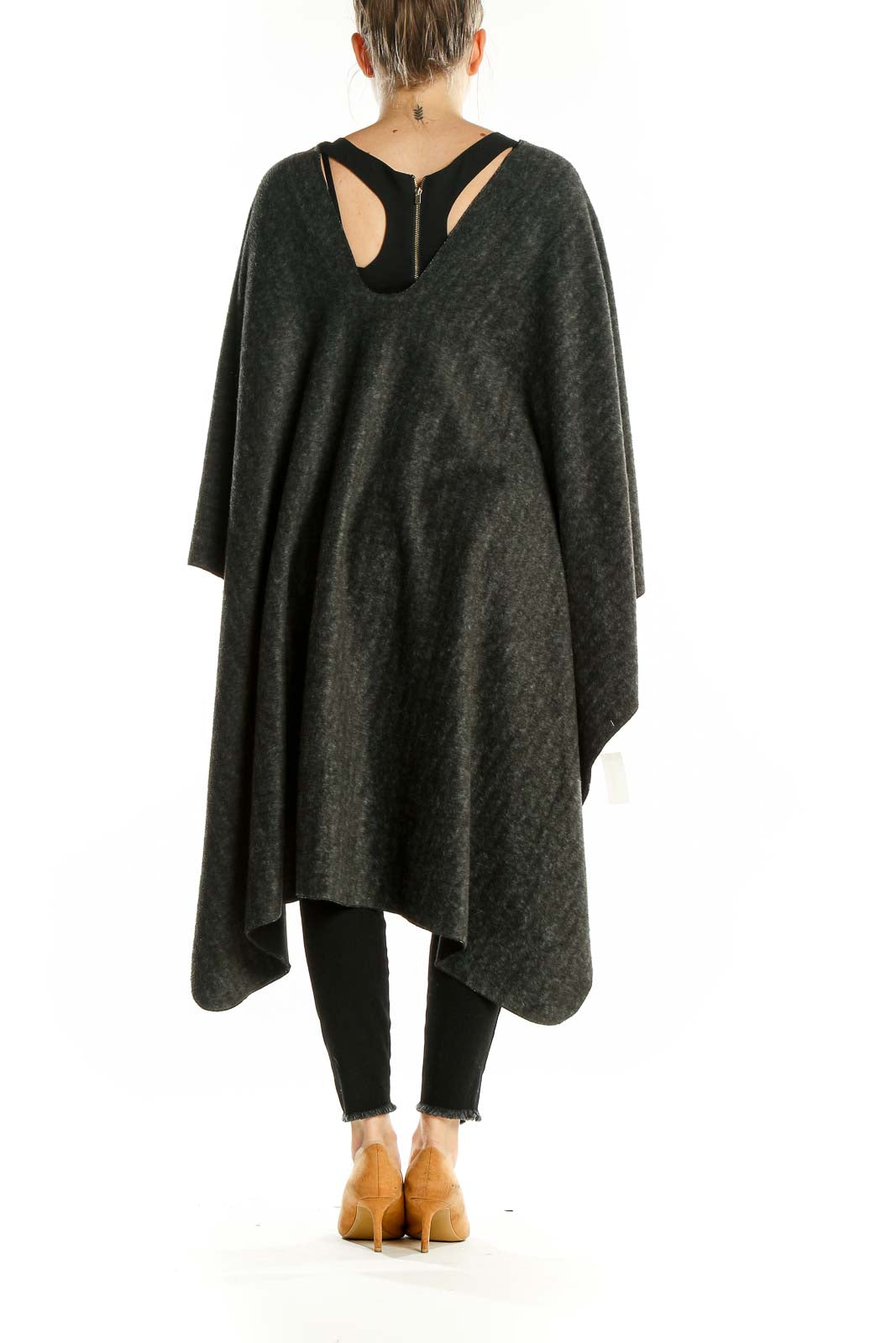 Back view of charcoal gray oversized knit poncho showing asymmetrical hem