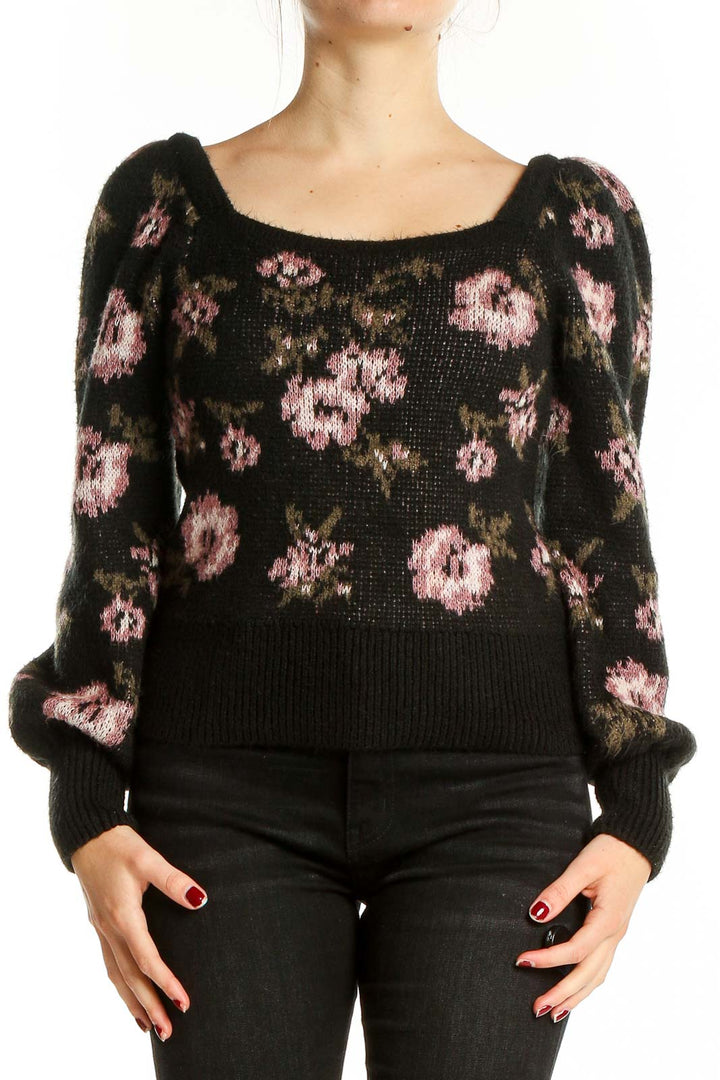 Front view of Anthropologie black knit sweater with pink floral pattern and puff sleeves