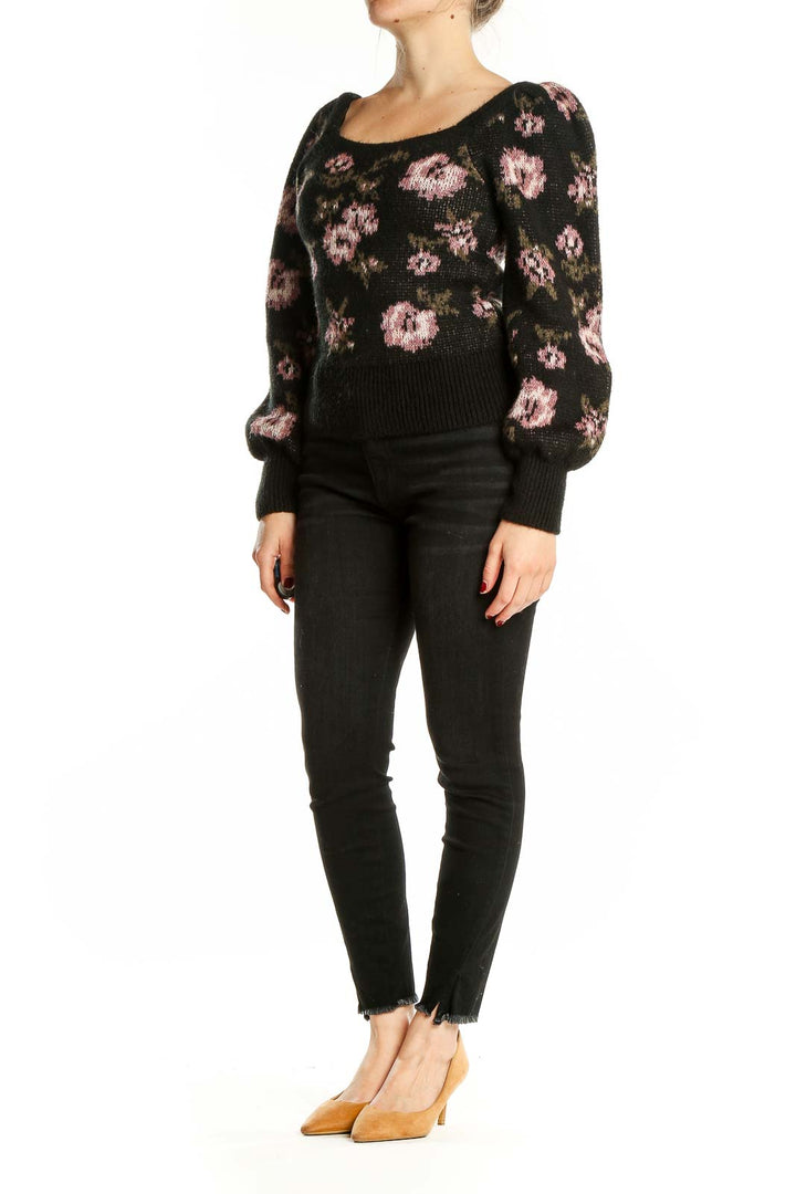 Front view of Anthropologie black knit sweater with pink floral pattern and puff sleeves