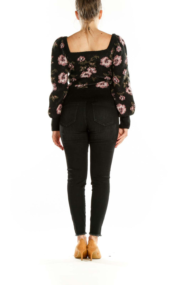 Back view of Anthropologie black floral knit sweater showing scoop neckline and puff sleeves