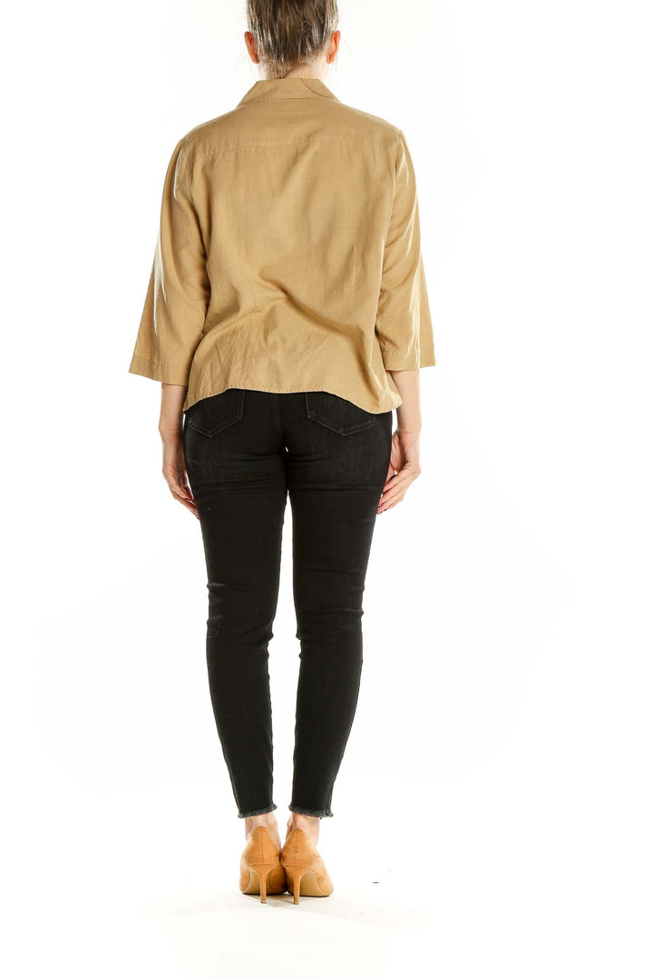 Back view of beige silk button-up blouse by Notations