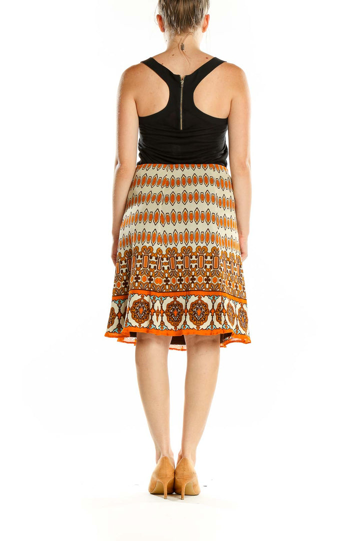 Back view of Nicole by Nicole Miller orange geometric print A-line skirt with black top