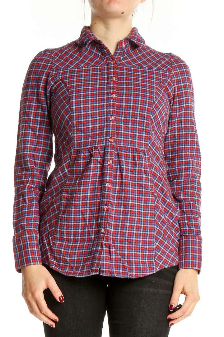 Front view of BDG red plaid cotton button-up shirt on model