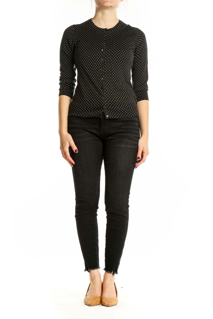 Front view of Banana Republic black polka dot cardigan with button-front closure