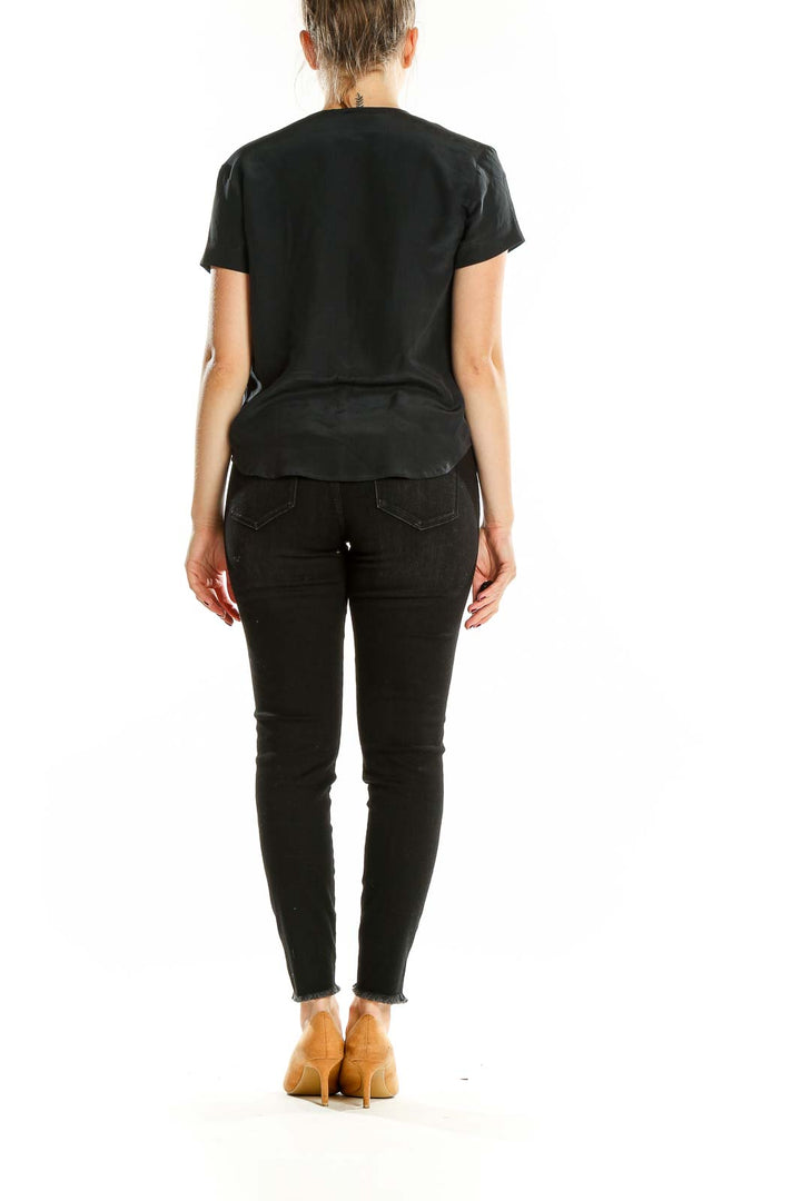 Back view of Jones New York black silk button-up short sleeve blouse on model