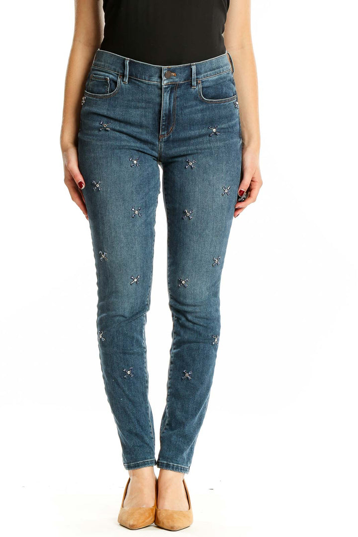 Front view of Ann Taylor blue embellished skinny jeans on model