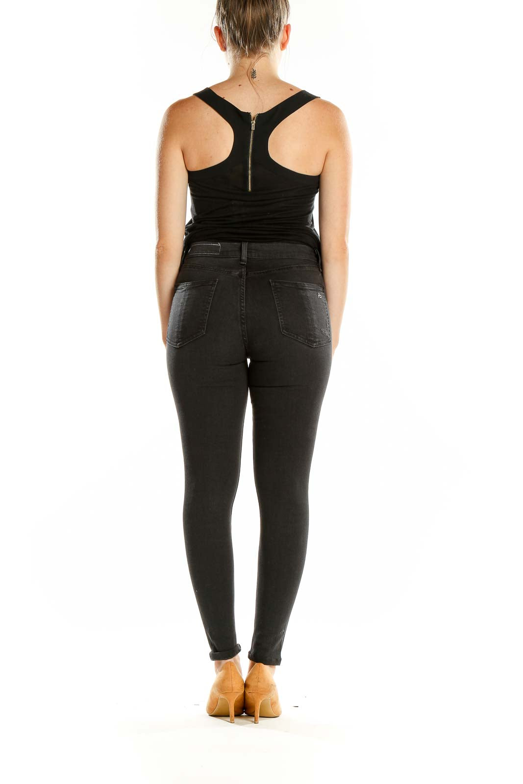 Back view of woman wearing Rag & Bone black distressed high-waisted skinny jeans