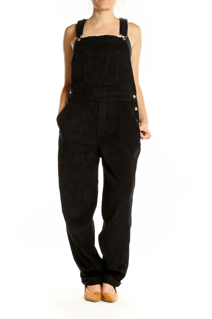 Front view of ASOS black overalls jumpsuit with wide legs and adjustable straps