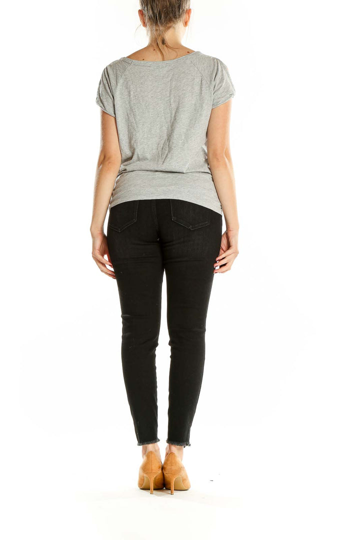 Back view of gray Sanctuary t-shirt on model with black jeans