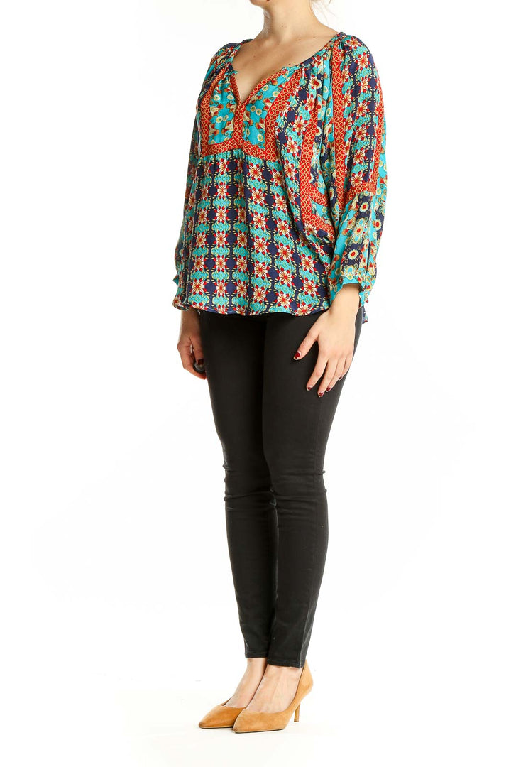 Front view of Tolani turquoise silk blouse with floral print and V-neckline