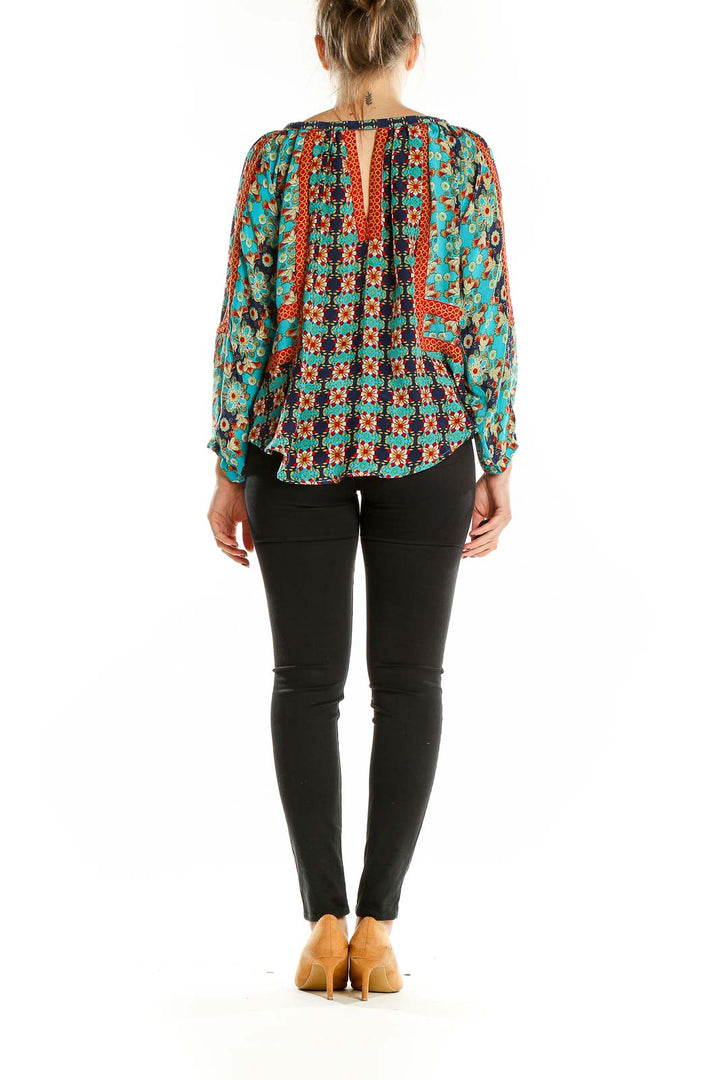 Back view of Tolani turquoise silk blouse showing flowy silhouette and pattern details