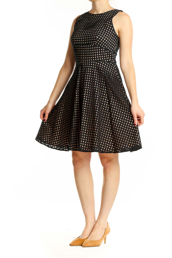 Front view of LOFT black cotton fit-and-flare dress with white polka dots