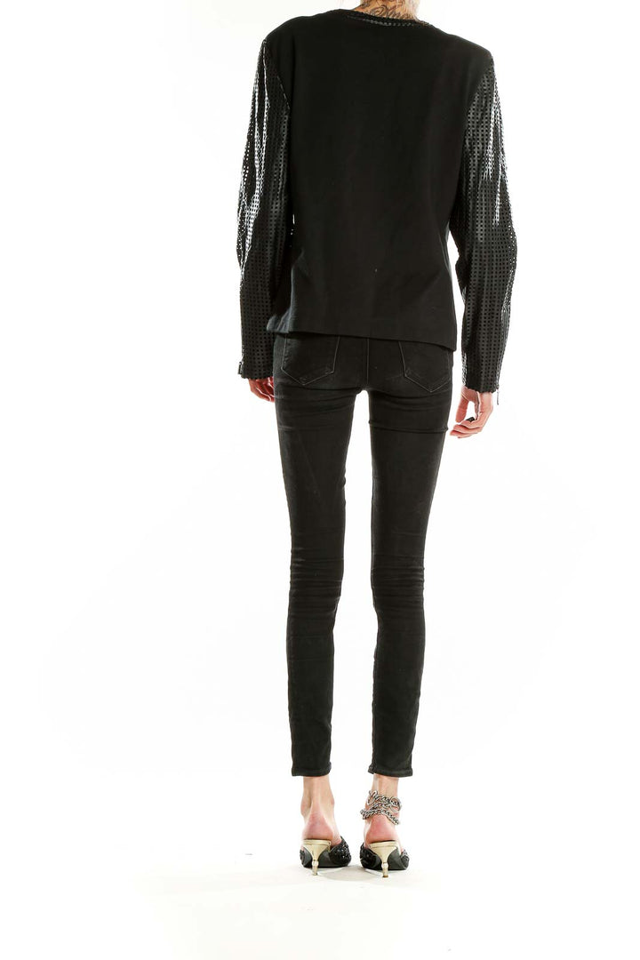 Back view of TART COLLECTIONS black jacket showing mesh sleeves and fitted silhouette