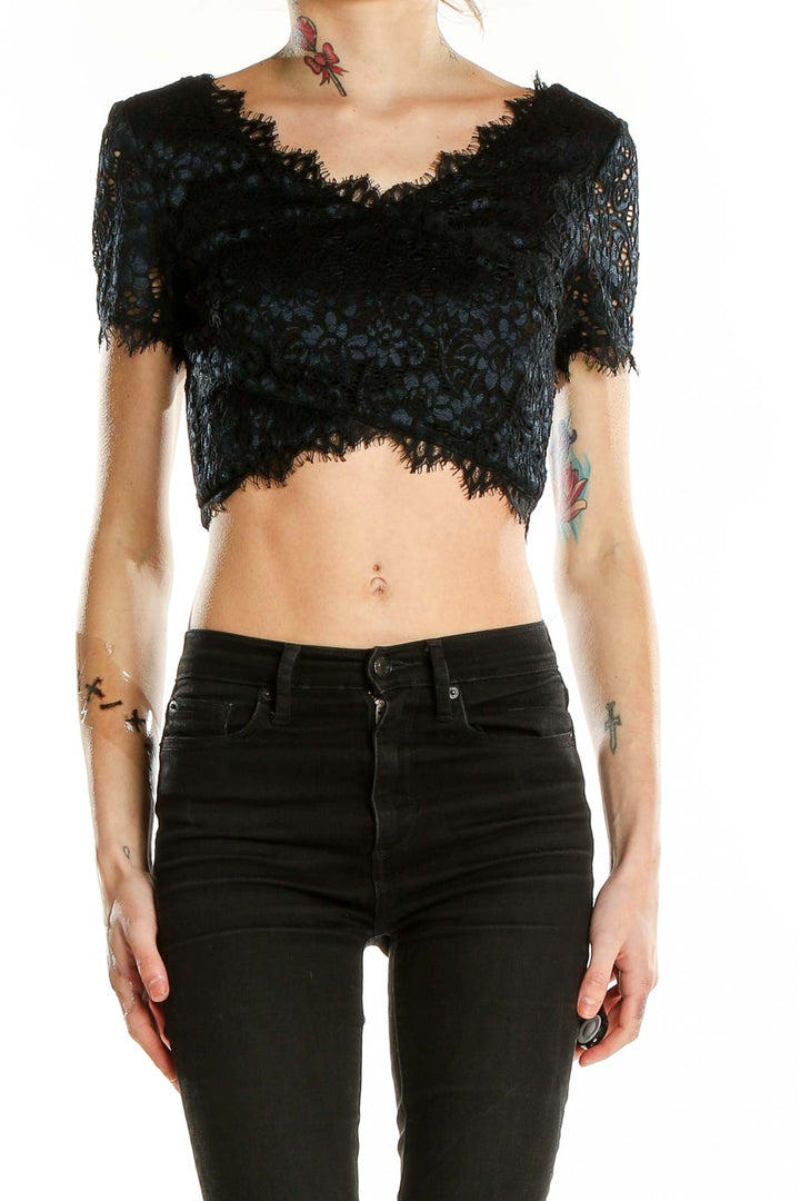 Front view of black lace crop top from Bebe with scalloped V-neckline