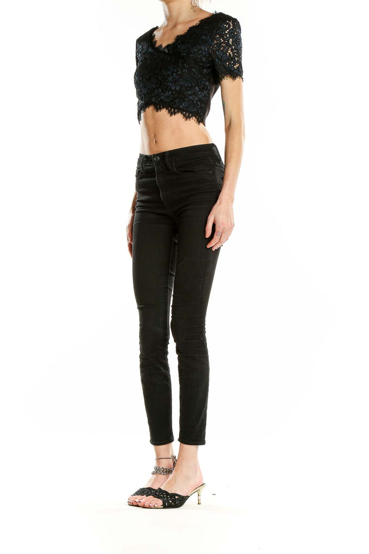 Front view of black lace crop top from Bebe with scalloped V-neckline